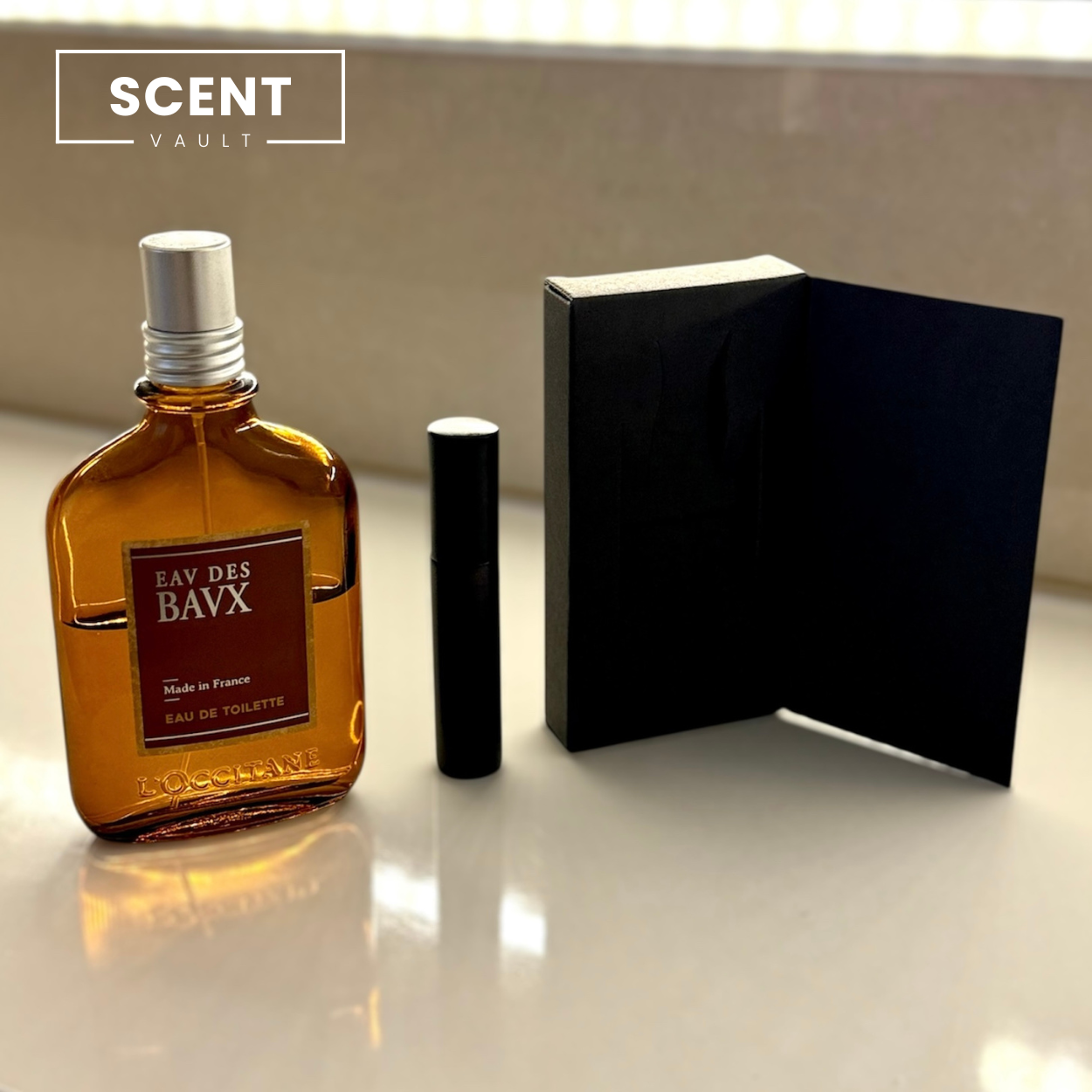 Brown perfume bottle with black cap and black box on a reflective surface, 'SCENT VAULT' branding visible.
