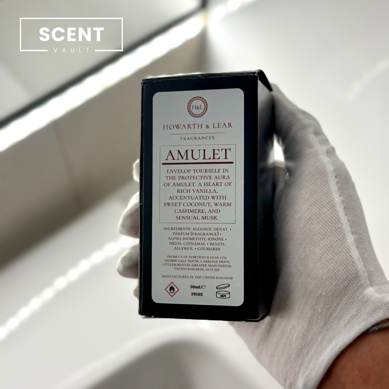 Hand holding a black box labeled 'Amulet' by Howarth & Lear with 'SCENT VAULT' branding.