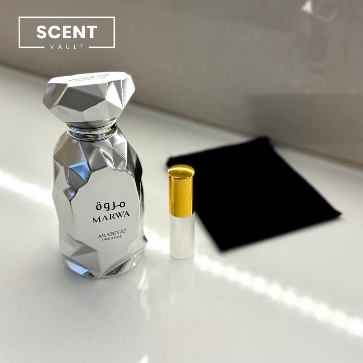Perfume bottle and luxury 5ml decant bottle on a white surface with 'Scent Vault' branding.