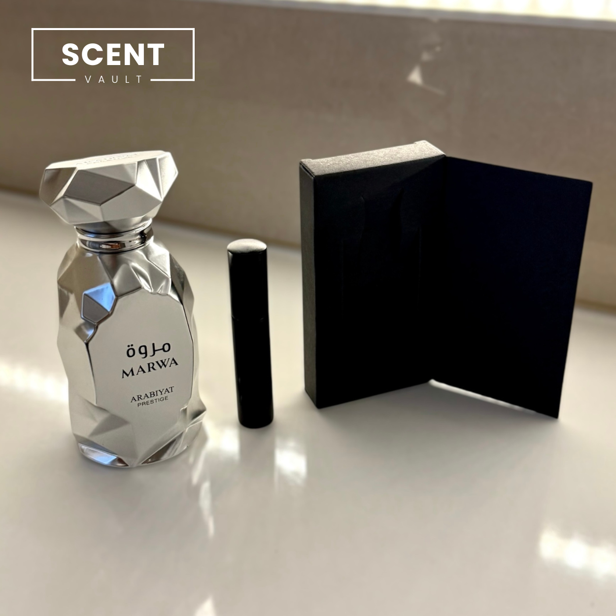 Perfume bottle and packaging on a reflective surface with 'SCENT VAULT' branding.
