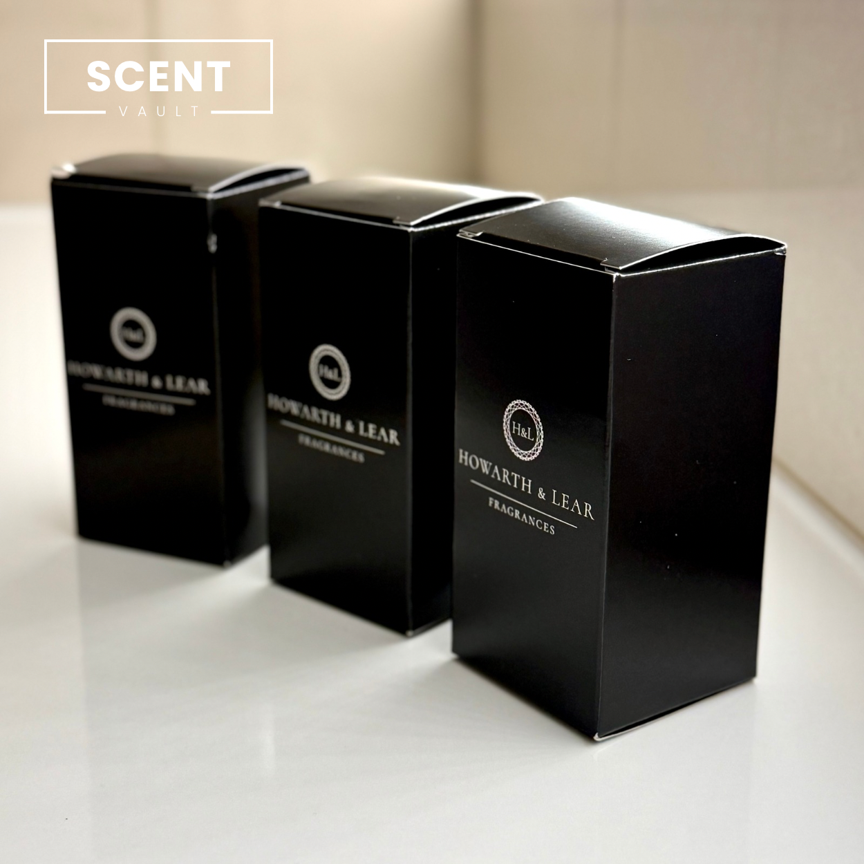Three black boxes from Howarth & Lear Fragrances on a light surface with 'Scent Vault' branding.