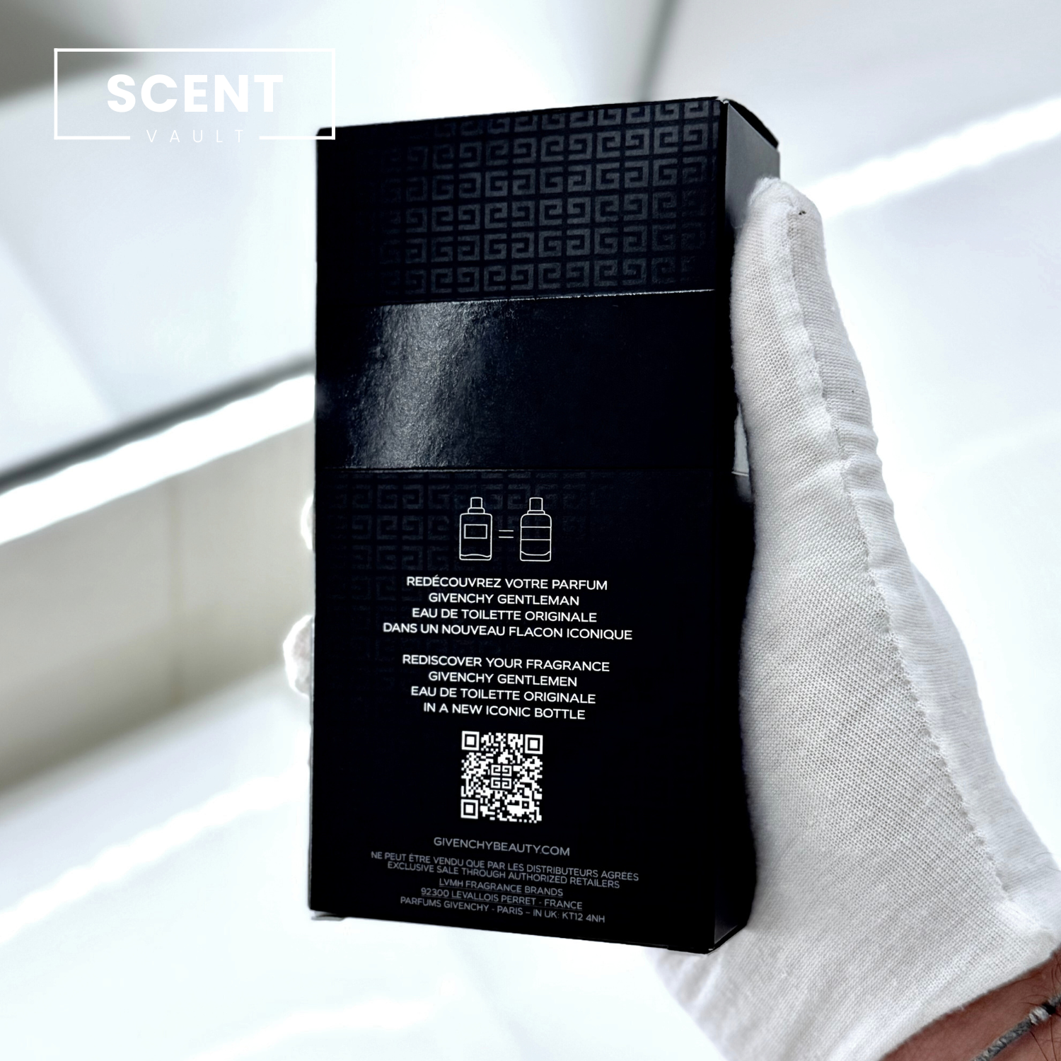Black perfume box held by a gloved hand with 'SCENT VAULT' branding.