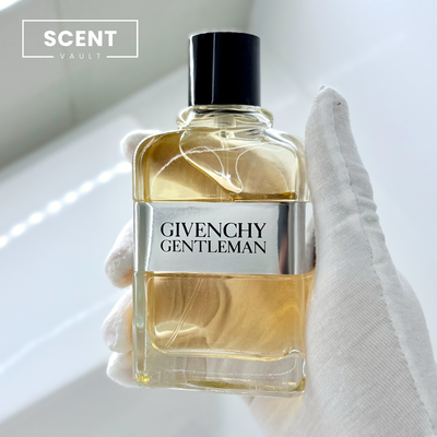 Givenchy Gentleman perfume bottle held by a gloved hand with 'Scent Vault' branding.