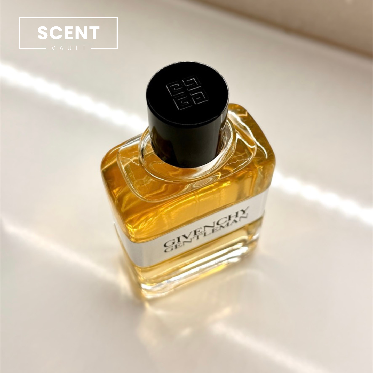 Givenchy cologne bottle on a reflective surface with 'Scent Vault' logo.