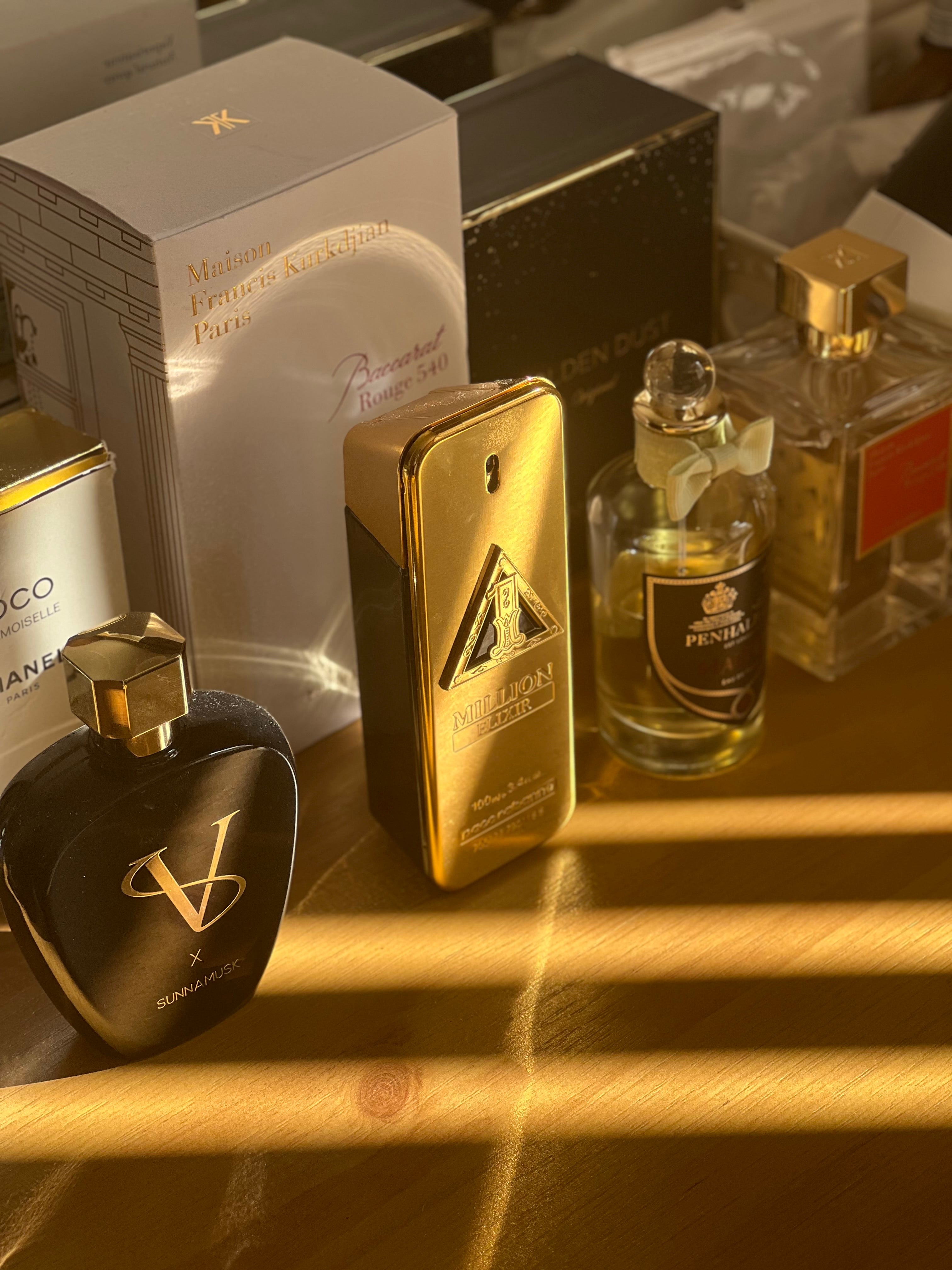 Display of luxury perfumes, including Maison Francis Kurkdjian Baccarat Rouge 540, Paco Rabanne 1 Million Elixir, Sunnamusk SV Oud, Penhaligon's Halfeti, & Coco Chanel Mademoiselle. Affordable decants for convenient sampling of premium fragrances, perfect to save money & explore luxury scents.