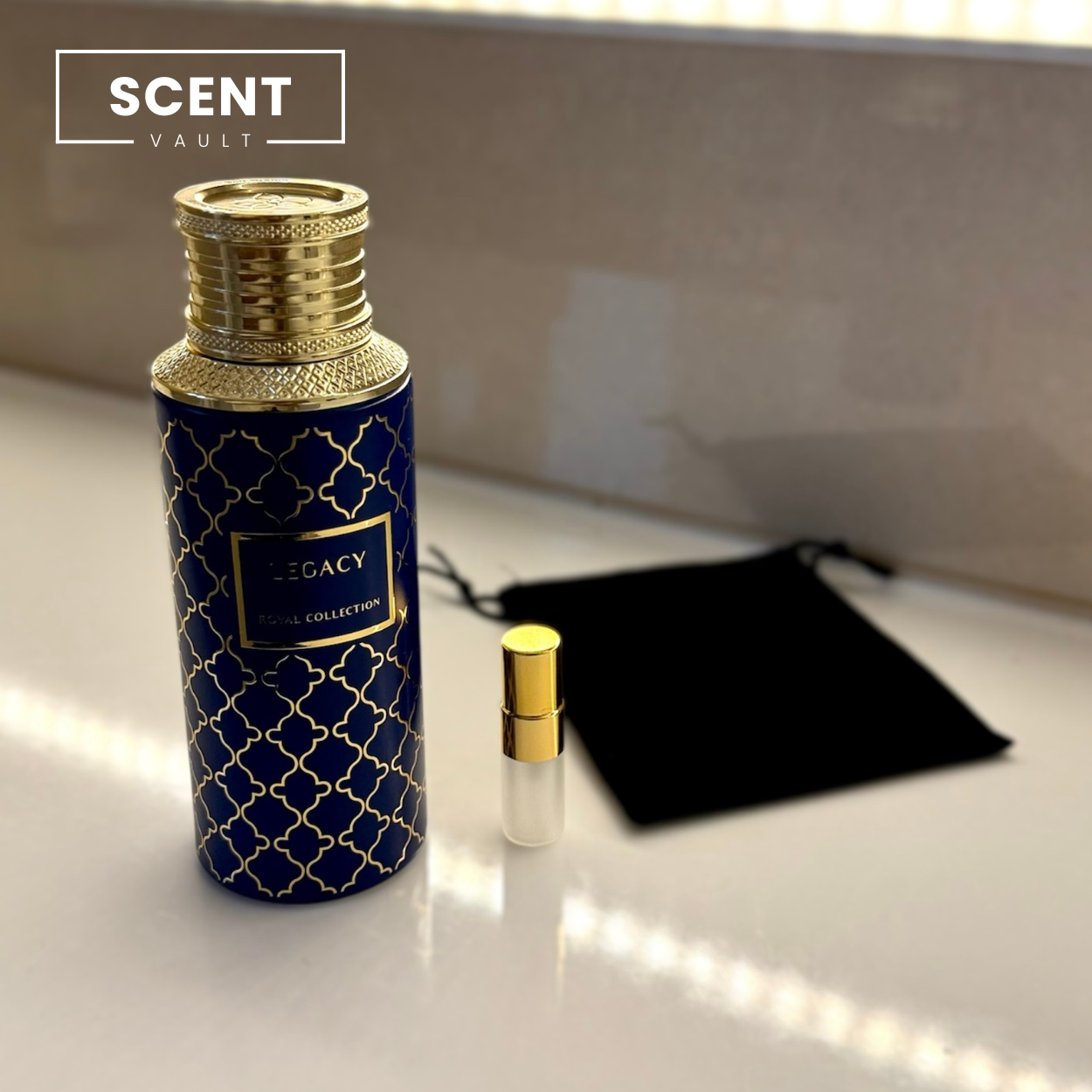 Perfume bottle with gold cap and blue design on a white surface, featuring 'Scent Vault' branding.