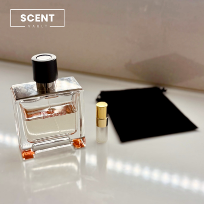 Hermès Terre d'Hermès Parfum bottle beside a decant spray vial and black velvet pouch - Scent Vault