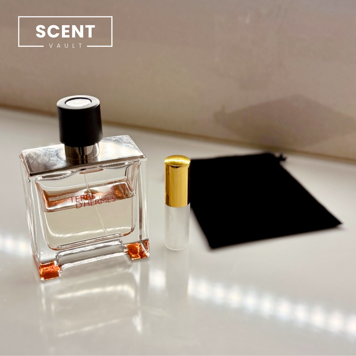 Hermès Terre d'Hermès Parfum perfume decants shown with the full bottle and velvet pouch - Scent Vault