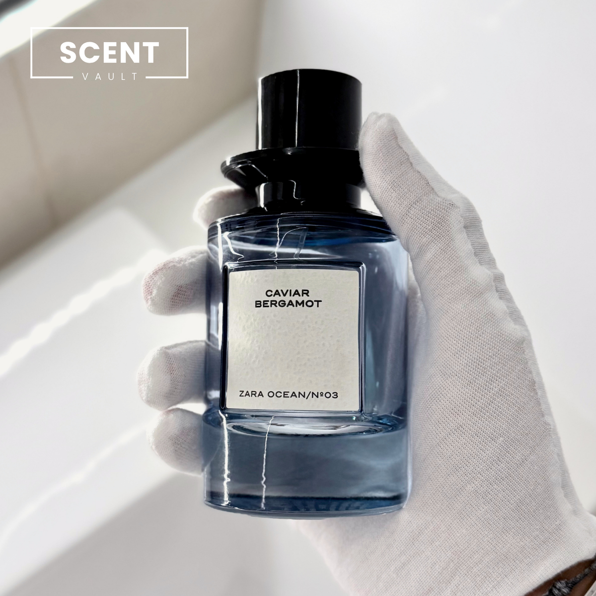 Zara x Jo Malone Caviar Bergamot blue glass bottle held in a gloved hand - Scent Vault