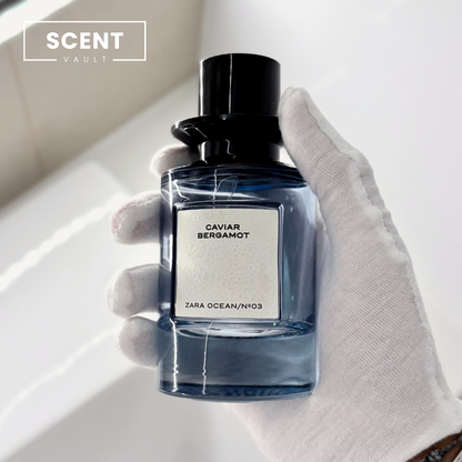 Zara x Jo Malone Caviar Bergamot blue glass bottle held in a gloved hand - Scent Vault